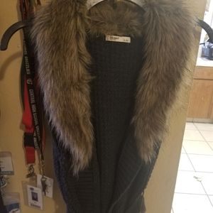 Dark grey sweater vest with faux fur trim.